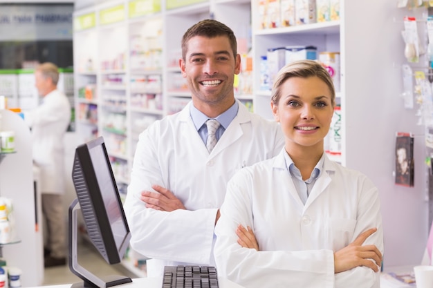 Team of pharmacists smiling at camera