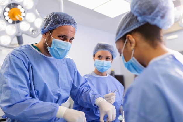 Team of professional doctors performing operation in surgery room Medical Team Performing Surgical Operation in Bright Modern Operating Room