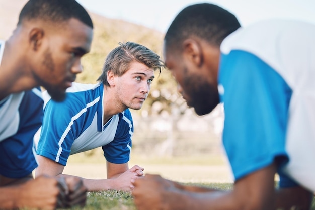 Team push up and football player coaching on field training practice and sports challenge with muscle support Group soccer people or men on grass or ground for workout fitness of personal trainer