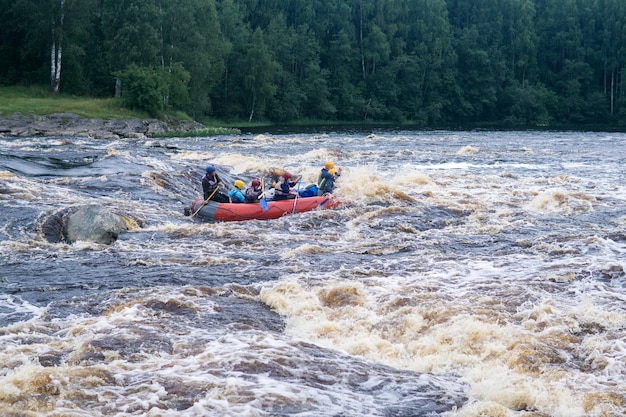 team on a raft passes the rapids on the Shuya River