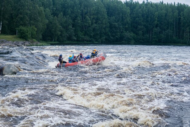 team on a raft passes the rapids on the Shuya River