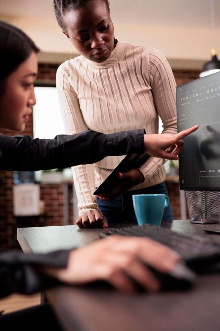 Photo team of software developers talking about source code running on computer, working with cloud computing terminal window. engineers working with user interface to develop new security firewall