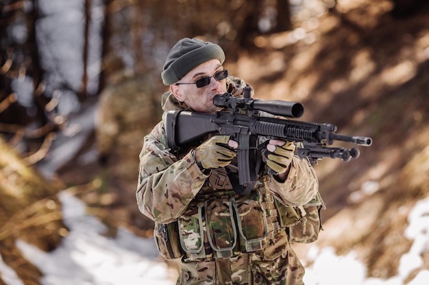 Team of special forces weapons in cold forest Winter warfare and military concept