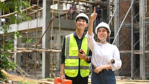 Team of specialists and Civil engineer inspecting industrial building construction site