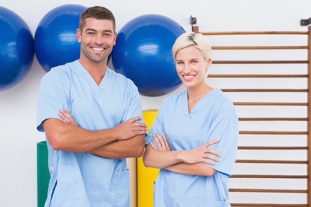 Team of therapists with arms crossed smiling at camera 