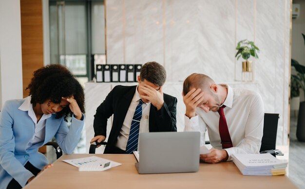 Photo team thinking of problem solution at modern office meeting sad diverse business people group shocked by bad news upset colleagues in panic after company bankruptcy concept