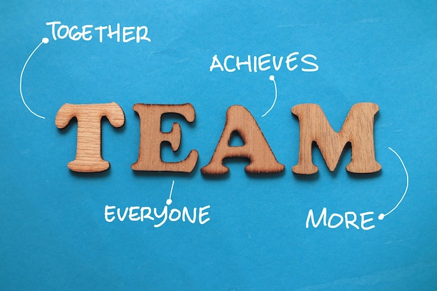 TEAM together everyone achieves more text words typography written on wooden