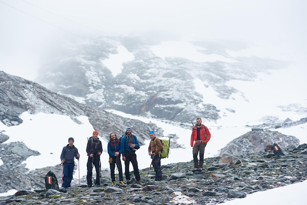 Premium Photo | Team of travelers standing on rocky mountain road