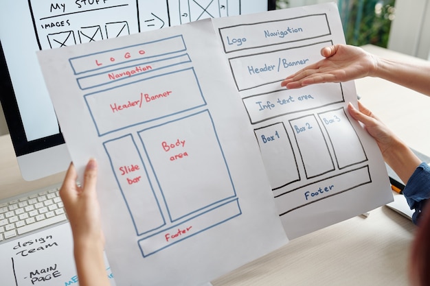 Team of UX designer discussing two versions of mobile device website variant at meeting