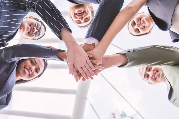 Team work of business diversity people man and woman hands together