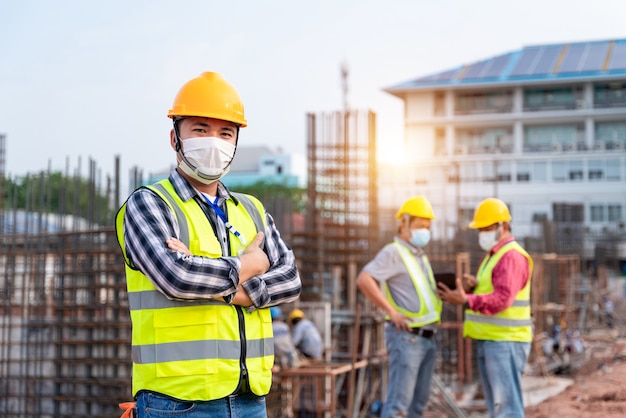 team work of construction engineers and architects supervising progress at construction site.