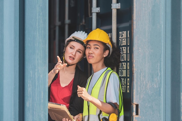 Team worker American women Work in an international shipping yard area Export and import delivery service with containers