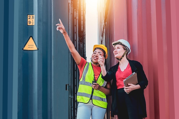 Team worker American women Work in an international shipping yard area Export and import delivery service with containers