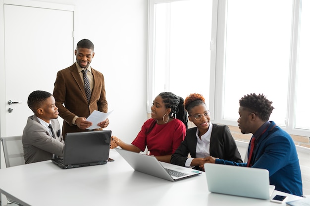 team of young african people in the office at the table with a laptop