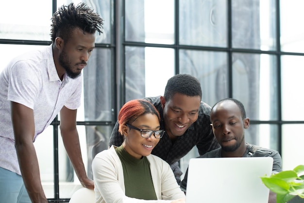 Team of young african people in the office working on laptop