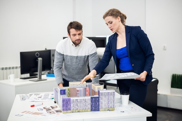 A team of young architects working on finalising their construction models