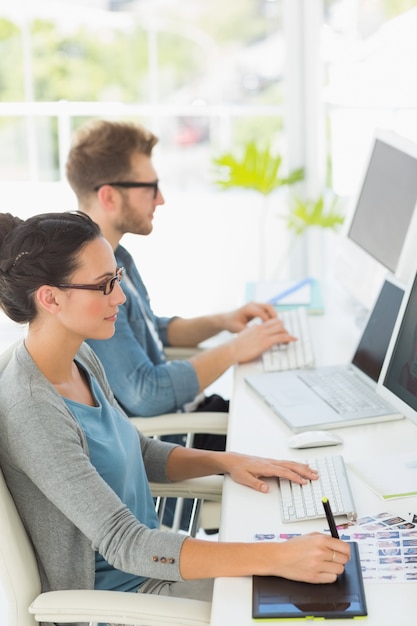 Team of young designers working at desk