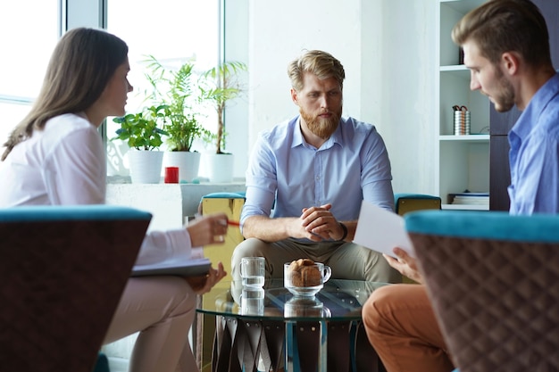 Team young professionals having casual discussion in office. Executives having friendly discussion during break