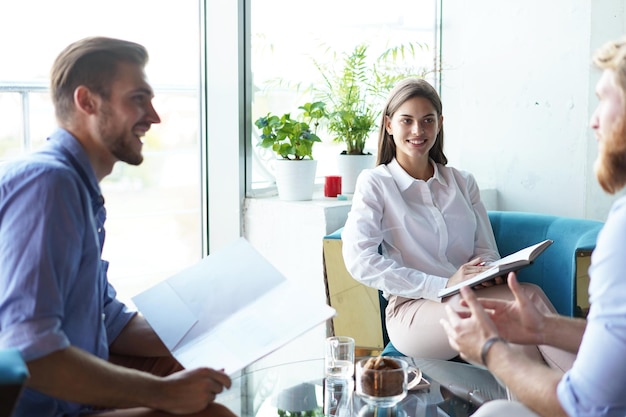 Team young professionals having casual discussion in office. Executives having friendly discussion during break.