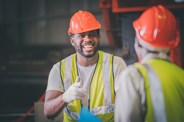 Teamwork african american worker in the factory black man afro\
work heavy industrial