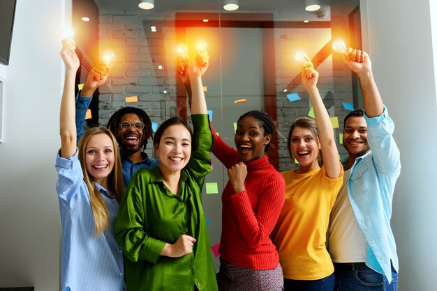 Photo teamwork of business person holds illuminated lightbulbs