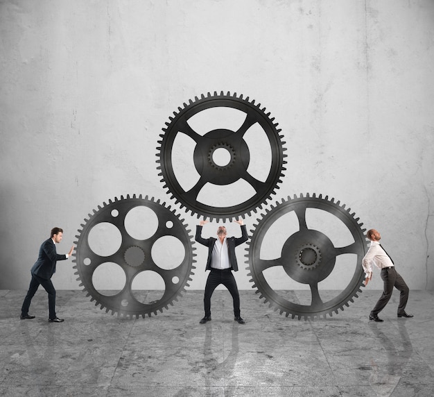 Teamwork of businesspeople work together to a system of gears