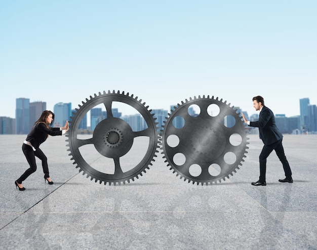 Teamwork of businesspeople work together to a system of gears