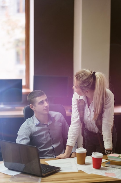 Photo teamwork communication cooperation coworkers discussing work related issues business office space