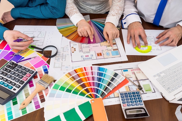 Teamwork of designers choosing colors for rooms in house