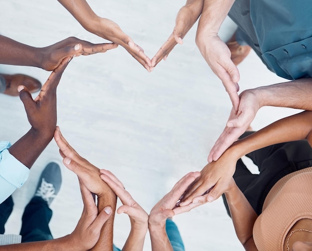 Teamwork hands heart and diversity partnership business people support or community care motivation and trust Above group team building for charity kindness and global solidarity love and hope