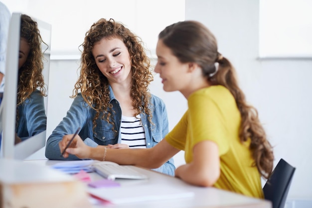 teamwork happy people or women writing notes in startup or research project in office desk leadership smile or woman helping training or speaking of business info or online networking to employee