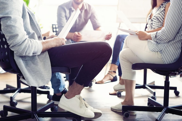 Teamwork is a key to success Business people in smart casual wear talking and smiling while having a brainstorm meeting in office