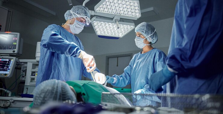 Photo teamwork medical and doctors working on a surgery for healthcare treatment in a theatre room collaboration career and professional surgeons doing an operation on a patient in a hospital or clinic