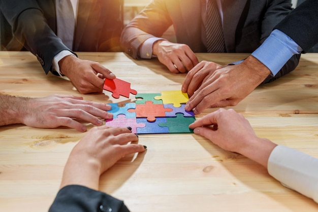 Teamwork of partners connect puzzle pieces as integration and startup