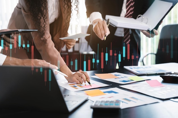 Teamwork process business team using a calculator to calculate\
the numbers of statistic business profits growth rate on documents\
graph data desk in the office