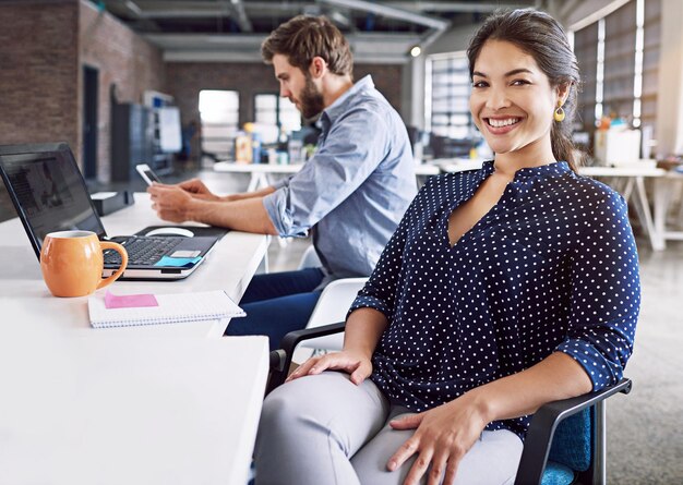 Photo teamwork smile and portrait of woman at desk with laptop and man at creative agency working on project together leadership collaboration and happy employees or business partner at design startup