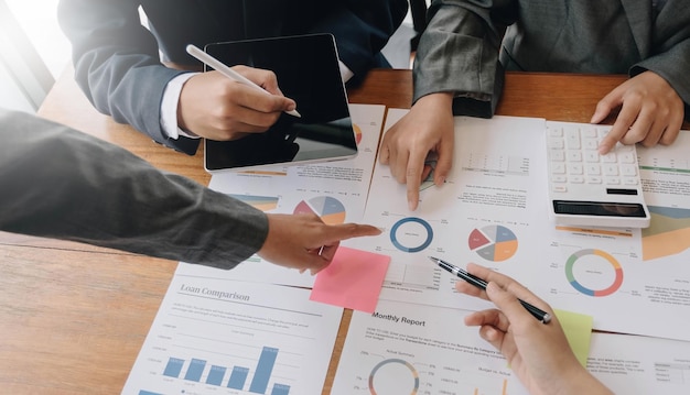 Teamwork with business people analysis cost graph on desk at meeting room