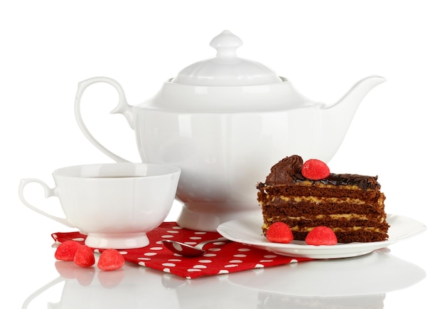 Teapot cup of tea and delicious cake isolated on white