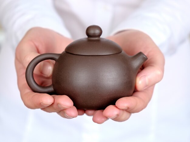 Teapot in her hands