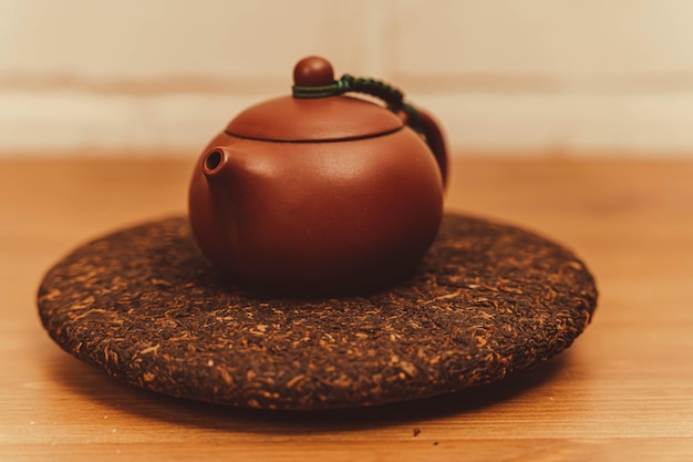 a teapot made of Yixing clay for making tea Pressed disc of Puerh black tea