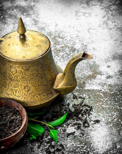 Teapot with black tea.