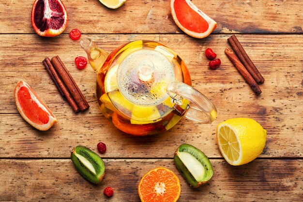 Teapot with citrus fruits