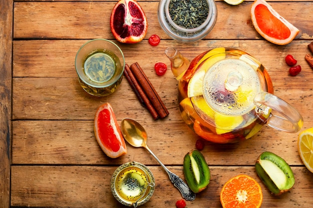 Teapot with citrus fruits