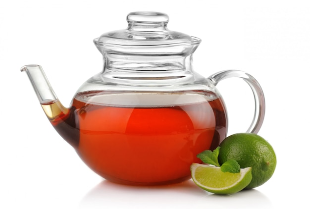 Teapot with fresh mint and lime isolated on white