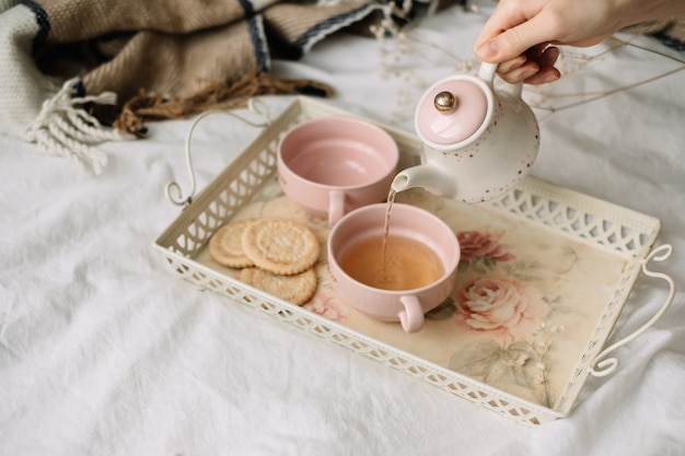 Teapot with tea and cups on a tray