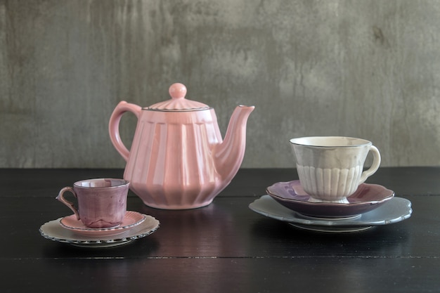 Teapot with teacup  ceramic on wood background.