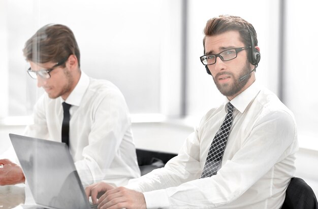 Tech support manager in headset consulting a clientphoto with copy space