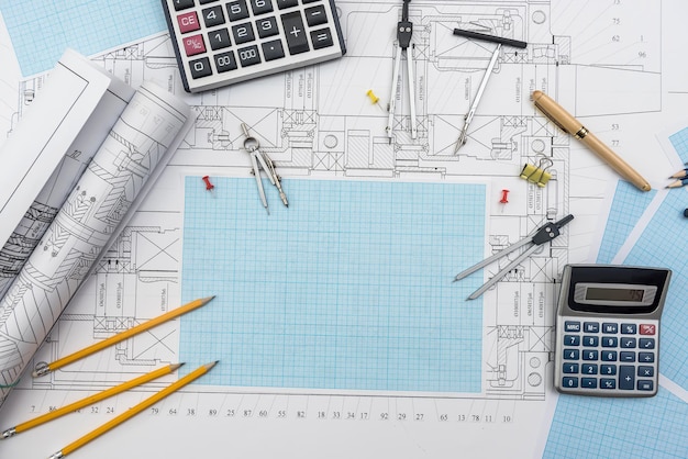 Technical drawing, graph paper and tools. Engineer  office team working with blueprints.