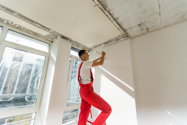 Technician of the air conditioning system is working on installing a new air conditioner in the apartment.