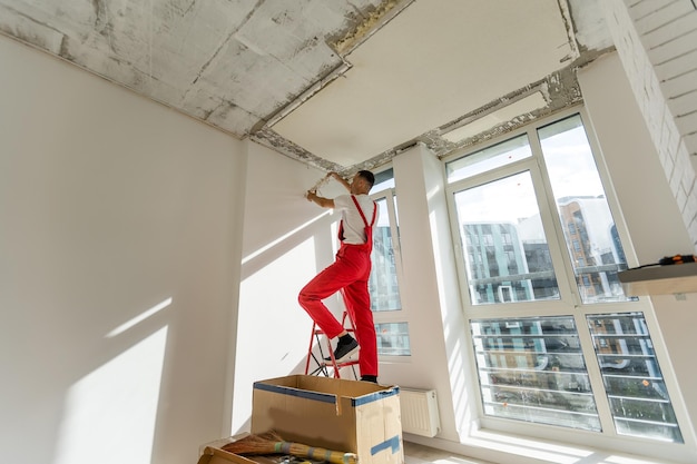 Technician of the air conditioning system is working on installing a new air conditioner in the apartment.